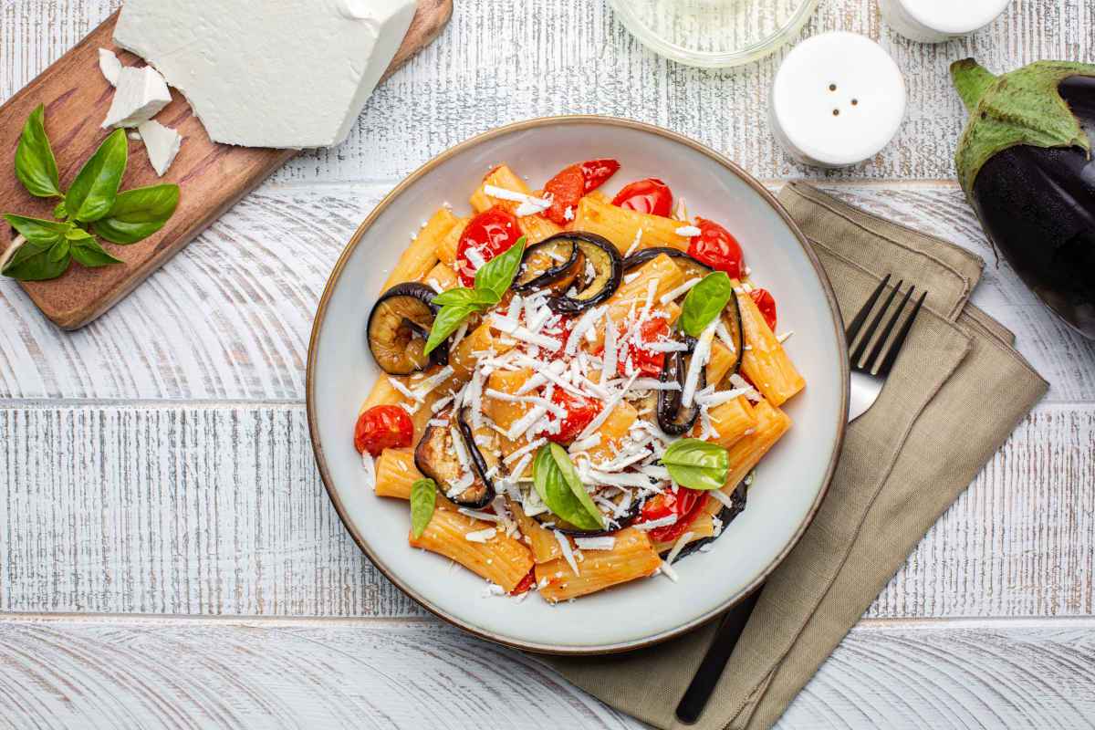 piatto di pasta alla norma con ricotta salata grattugiata